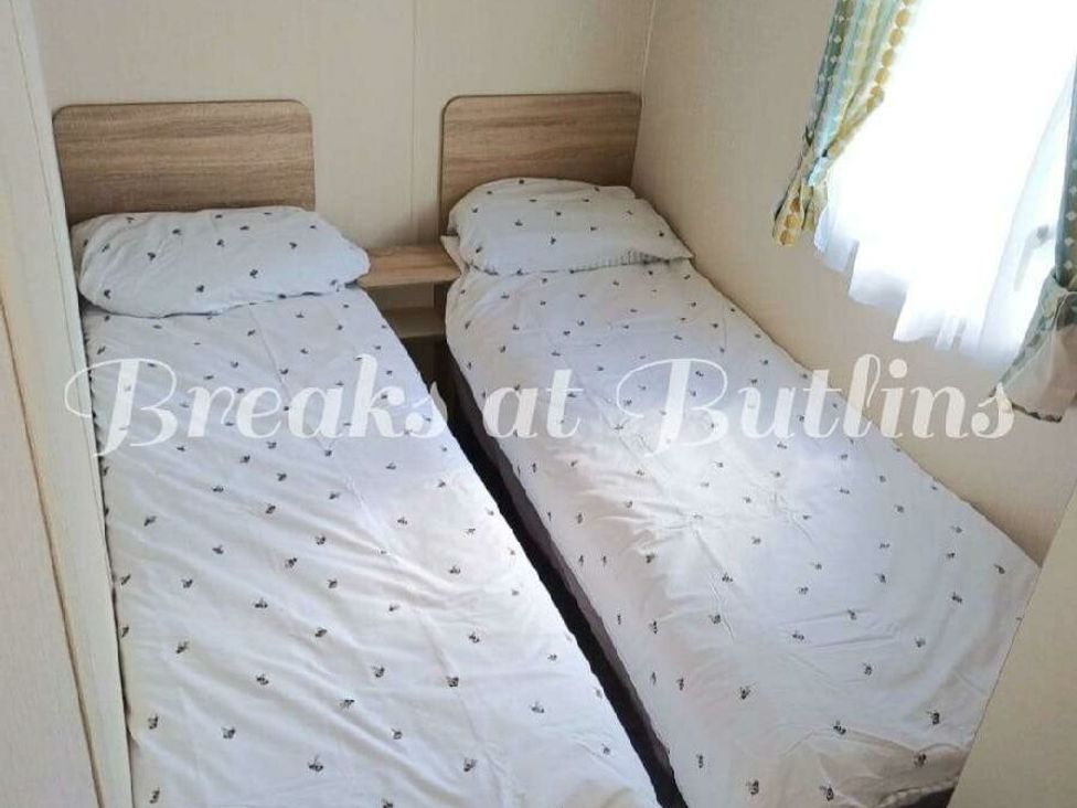 a room with two single beds and a window with curtains at Butlins Minehead - Holiday Accommodation 18045 in Minehead