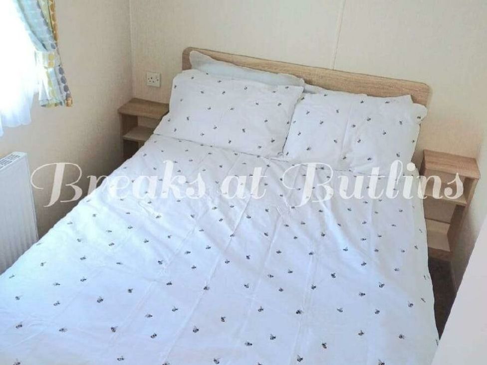 a double bed with white bedding and bedside tables at Butlins Minehead - Holiday Accommodation 18045 in Minehead