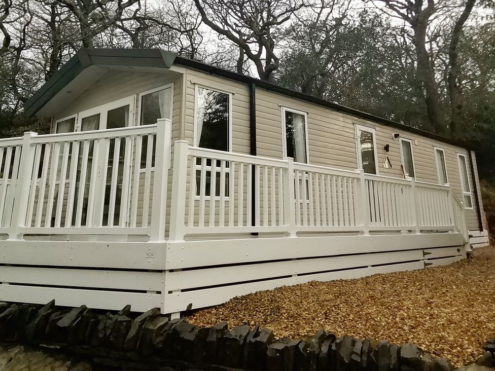 A holiday home with decking and windows at Aberdunant Hall Holiday Park - Holiday Accommodation 19035, Porthmadog