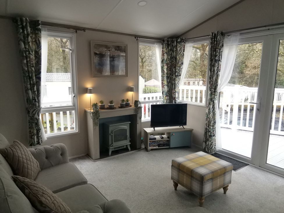 A living room with a sofa and television at Aberdunant Hall Holiday Park - Holiday Accommodation 19035, Porthmadog