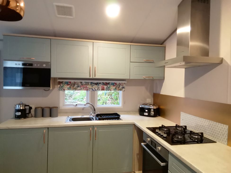 A kitchen with a sink and cooking hob at Aberdunant Hall Holiday Park - Holiday Accommodation 19035 Porthmadog