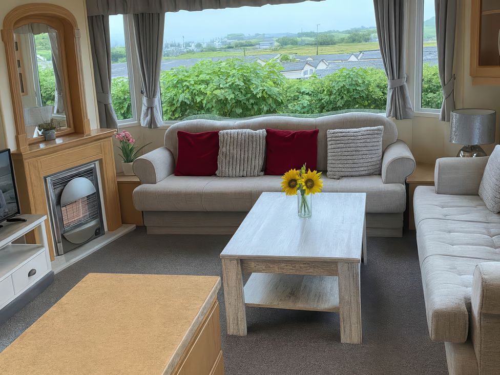 A living room with a sofa and coffee table at Brynowen Holiday Park - Holiday Accommodation 19041 Borth Mis Wales
