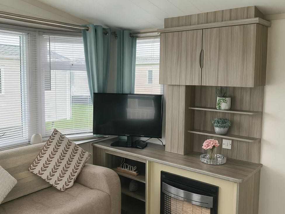 A living room with a sofa, tv, and shelves at Whitehouse Leisure Park - Holiday Accommodation 19055 Towyn, Abergele