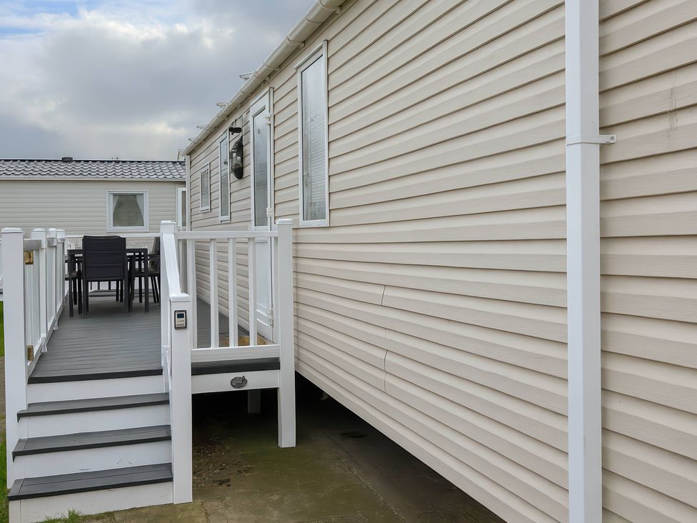 An outdoor area with a deck and seating at Whitehouse Leisure Park - Holiday Accommodation 19055, Towyn, Abergele
