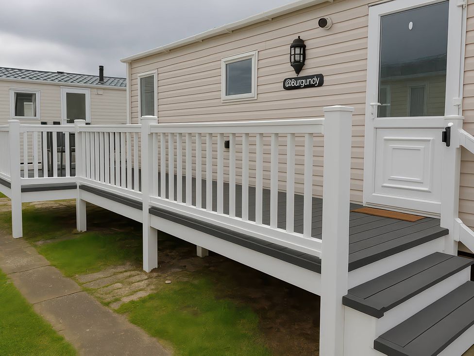 An outdoor deck with steps leading to a door at Whitehouse Leisure Park - Holiday Accommodation 19055, Towyn, Abergele