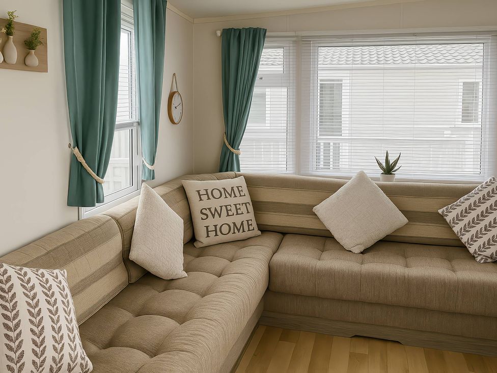 A living room with a sofa and pillows at Whitehouse Leisure Park - Holiday Accommodation 19055 in Towyn, Abergele
