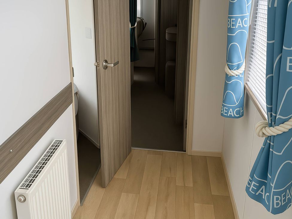 A hallway with a door and curtains at Whitehouse Leisure Park - Holiday Accommodation 19055, Towyn, Abergele