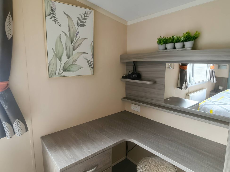 A bedroom with a desk and mirror at Whitehouse Leisure Park - Holiday Accommodation 19057, Towyn, Abergele