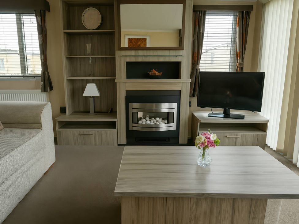 A living room with furniture including a sofa, coffee table, and television at Whitehouse Leisure Park - Holiday Accommodation 19057, Towyn, Abergele