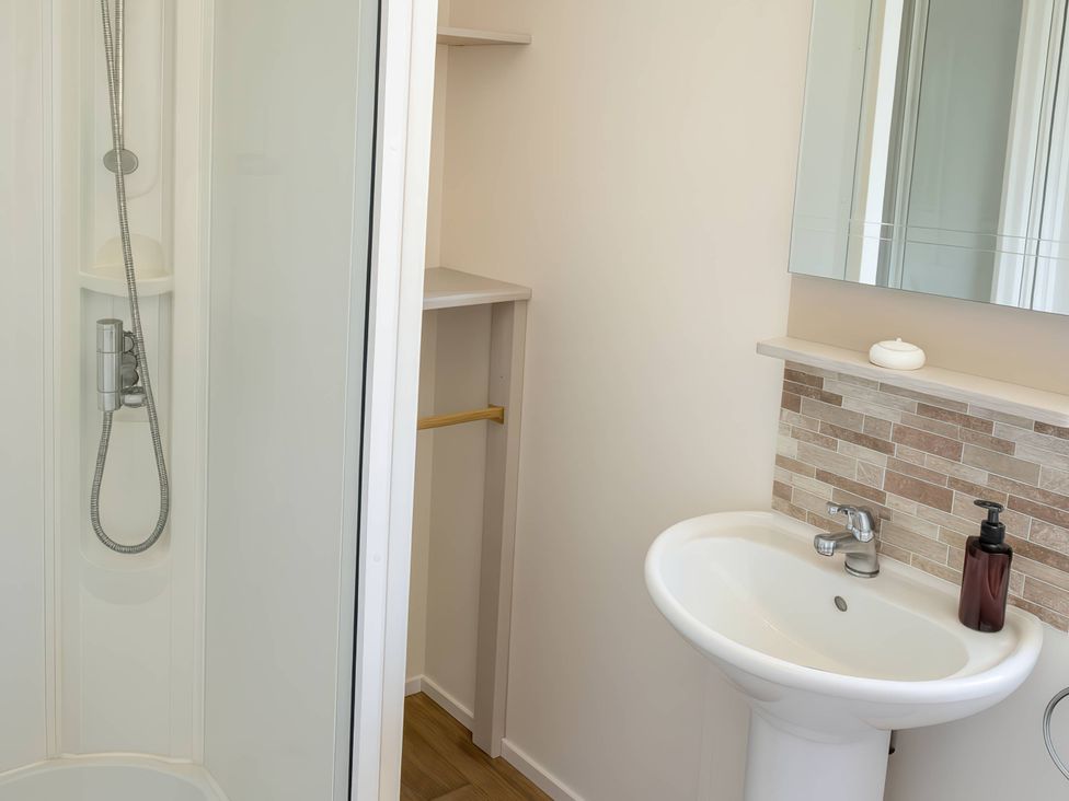 A bathroom with a shower and sink at Golden Gate Holiday Centre - Holiday Accommodation 19058, Towyn