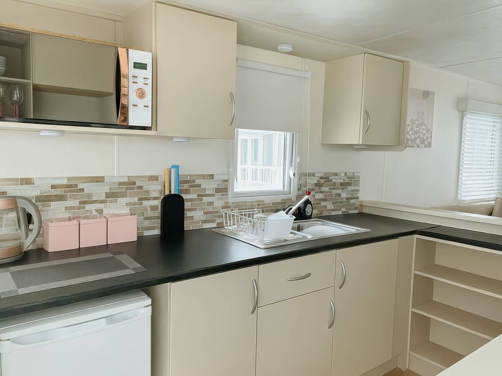 A kitchen with a sink and appliances at Golden Gate Holiday Centre - Holiday Accommodation 19058 Towyn