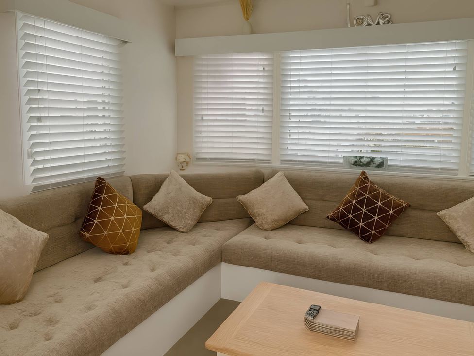 A living room with a sofa and cushions at Golden Gate Holiday Centre - Holiday Accommodation 19058, Towyn