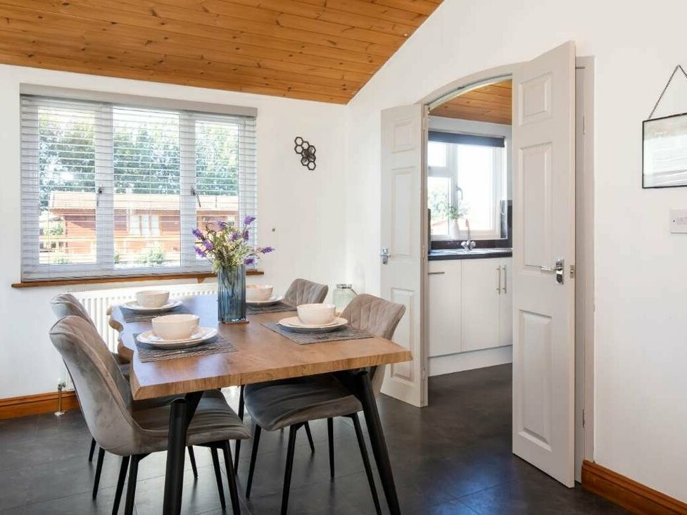 a dining area with a table and chairs, a kitchen visible through an open door at Florida Keys Holiday Park - Holiday Accommodation 19291, York