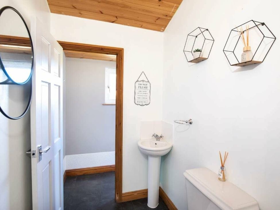 a bathroom with a sink, toilet, and decorative shelves at Florida Keys Holiday Park - Holiday Accommodation 19291, York