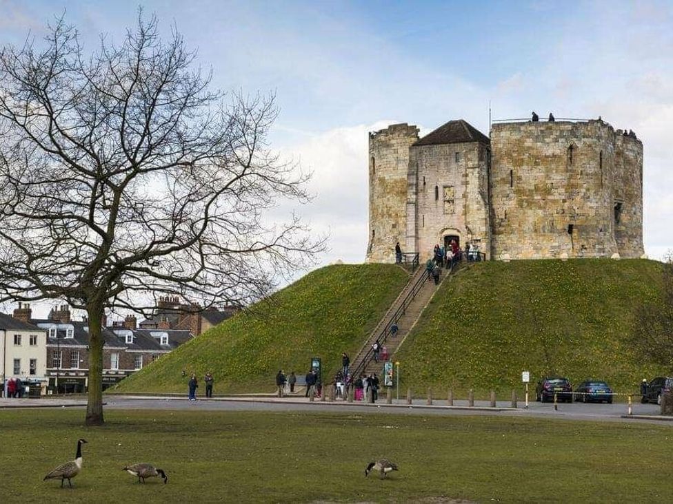a historic castle on a hill with people walking up the stairs at Florida Keys Holiday Park - Holiday Accommodation 19291, York