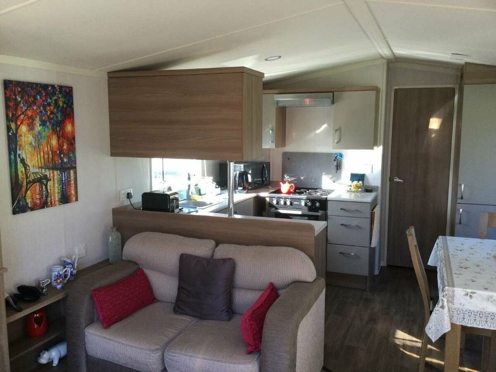 a living room and kitchen area with a sofa and cooking space at Hunters Quay Holiday Village - Holiday Accommodation 19798 in Dunoon