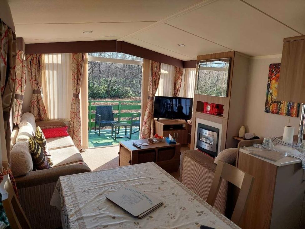 a living room with a television and a dining area at Hunters Quay Holiday Village - Holiday Accommodation 19798 Dunoon
