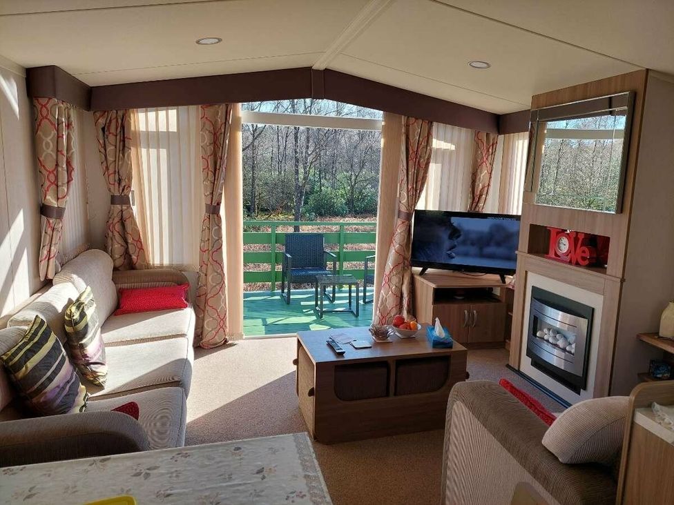 a living room with a television and seating at Hunters Quay Holiday Village - Holiday Accommodation 19798 Dunoon