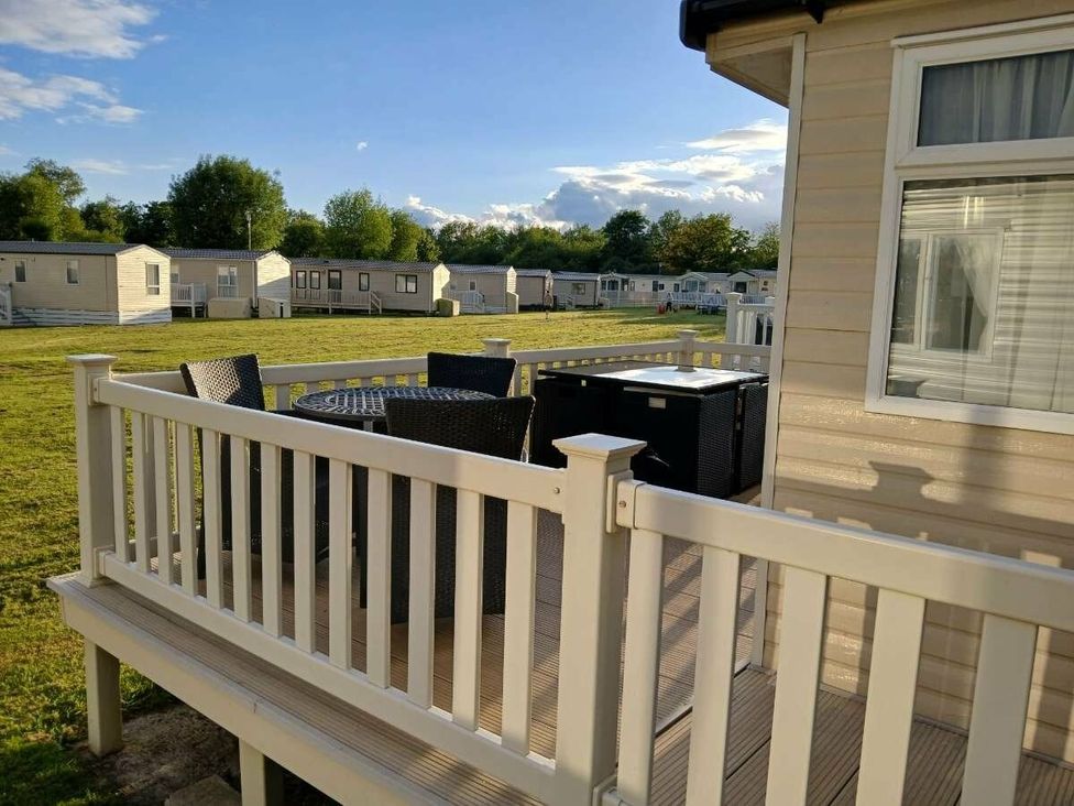 a deck with outdoor furniture at Hoburne Cotswolds - Holiday Accommodation 20158 in South Cerney