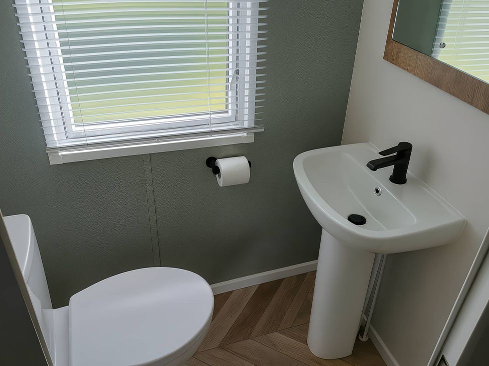 A bathroom with a toilet and sink at Lakeland Leisure Park - Holiday Accommodation 20349 in Grange-Over-Sands
