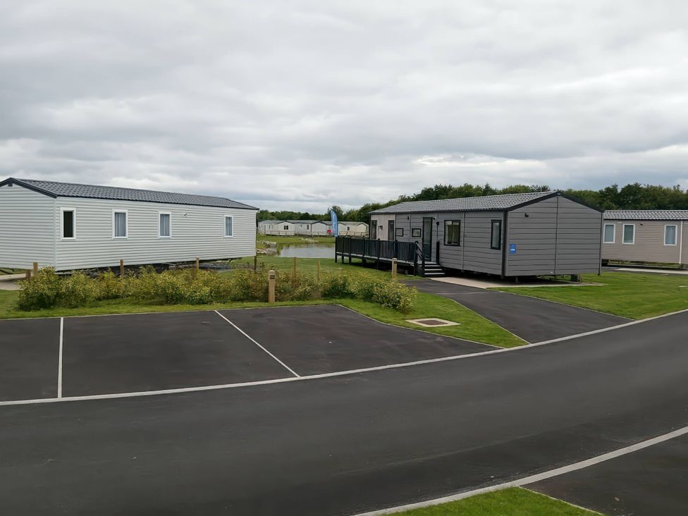 Two static caravans with a parking area at Lakeland Leisure Park - Holiday Accommodation 20349 Grange-Over-Sands
