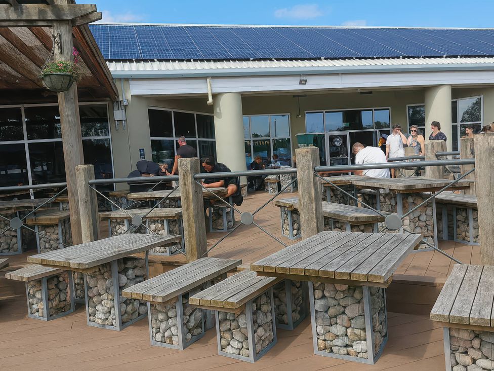 An outdoor seating area with tables and chairs at Lakeland Leisure Park - Holiday Accommodation 20349 Grange-Over-Sands
