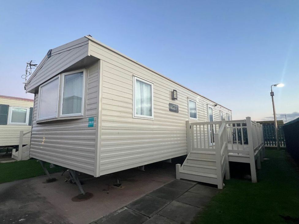 a caravan with a deck and steps at Golden Sands Kinmel Bay - Holiday Accommodation 20528 Rhyl