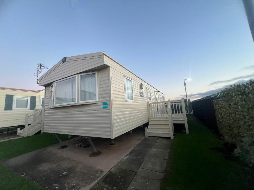 a caravan with a deck and steps at Golden Sands Kinmel Bay - Holiday Accommodation 20528 in Rhyl