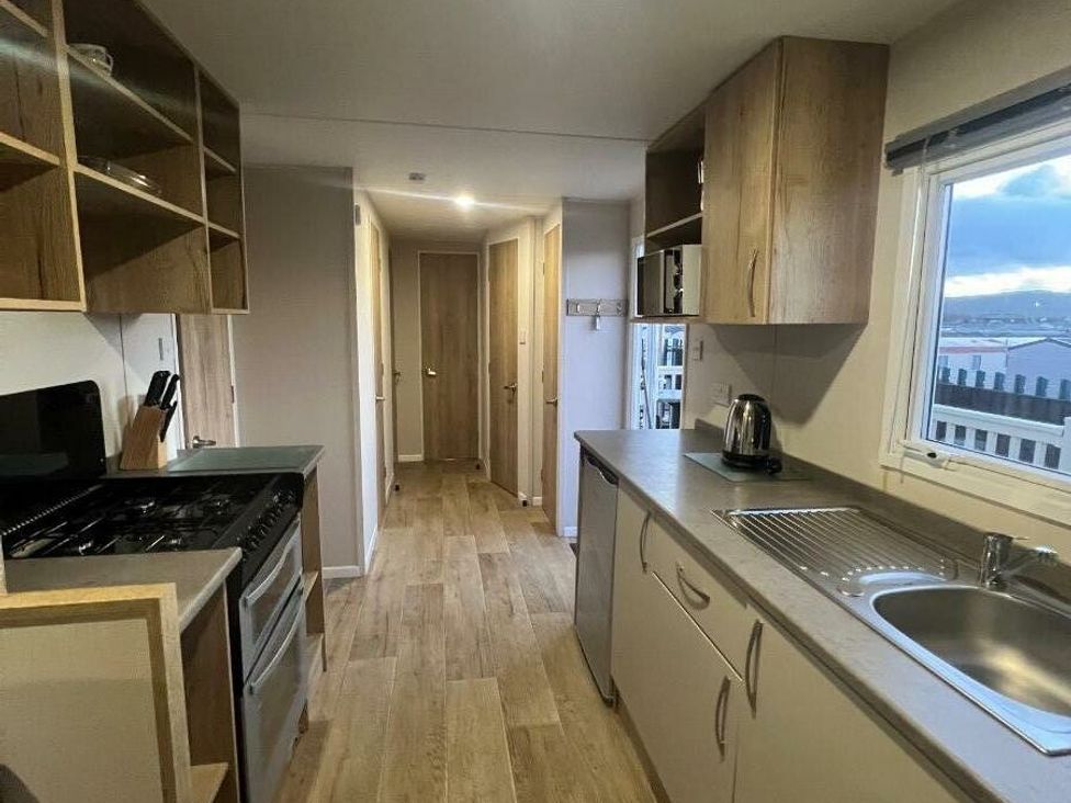 a kitchen with cabinets and appliances at Golden Sands Kinmel Bay - Holiday Accommodation 20528 Rhyl