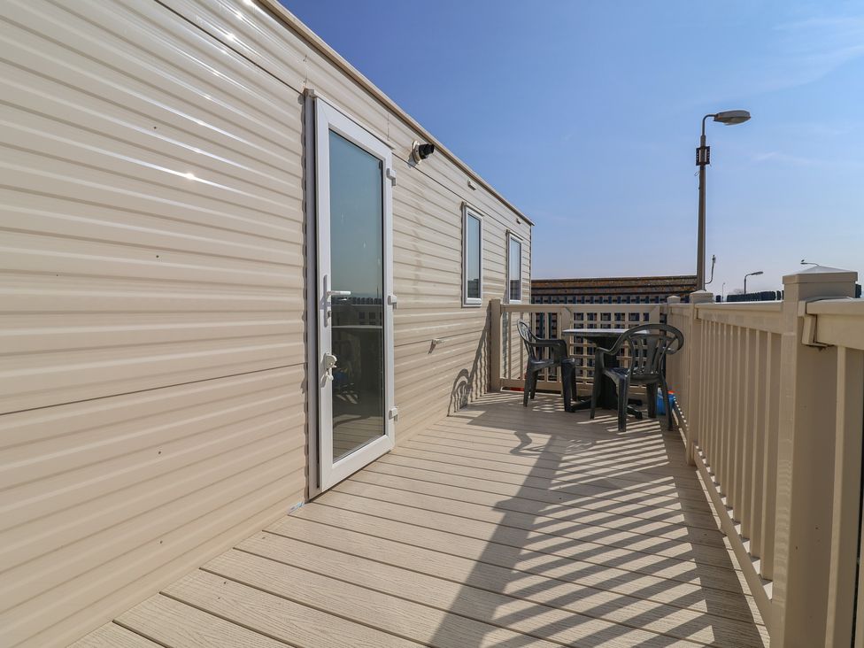 An outdoor area with a table and chairs at Golden Sands Kinmel Bay - 20528 Rhyl