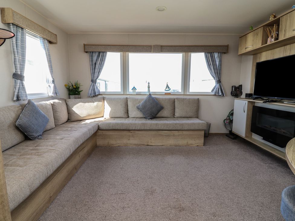 A living room with a sofa and television at Golden Sands Kinmel Bay - 20528 Rhyl