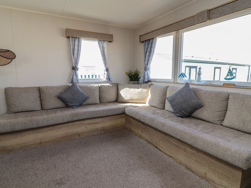 A snug with a corner sofa and window at Golden Sands Kinmel Bay - 20528, Rhyl