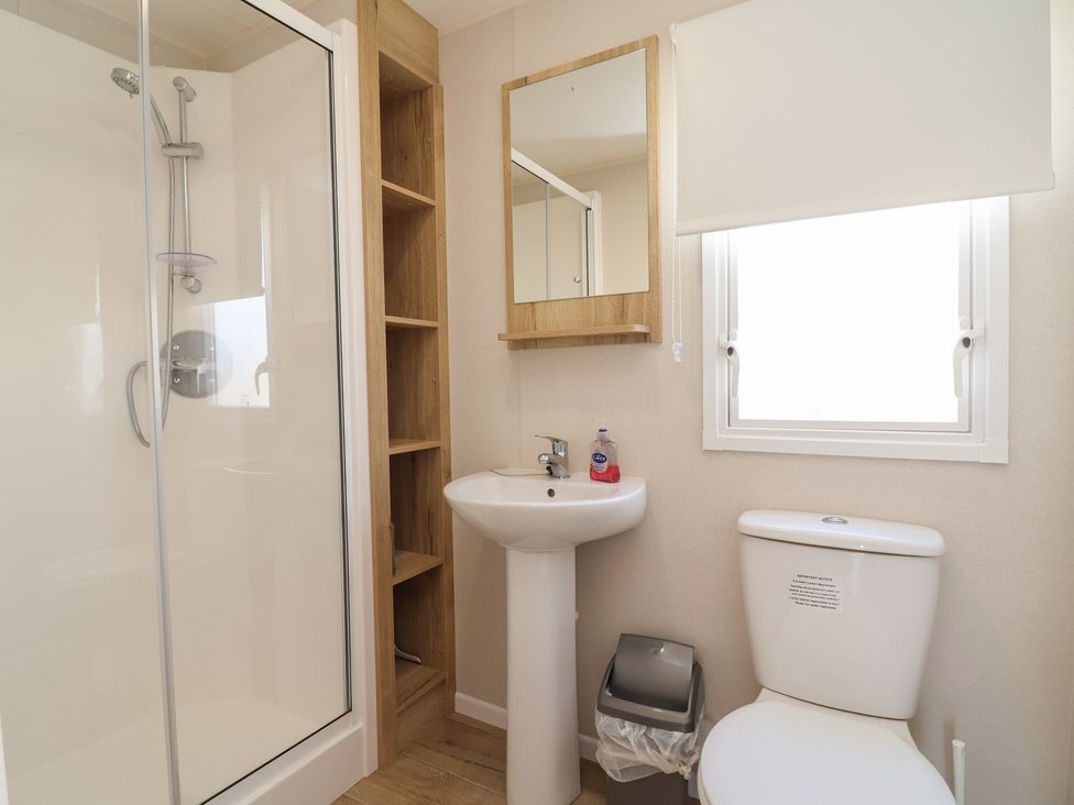 A bathroom with a shower, sink, and toilet at Golden Sands Kinmel Bay - 20528 in Rhyl