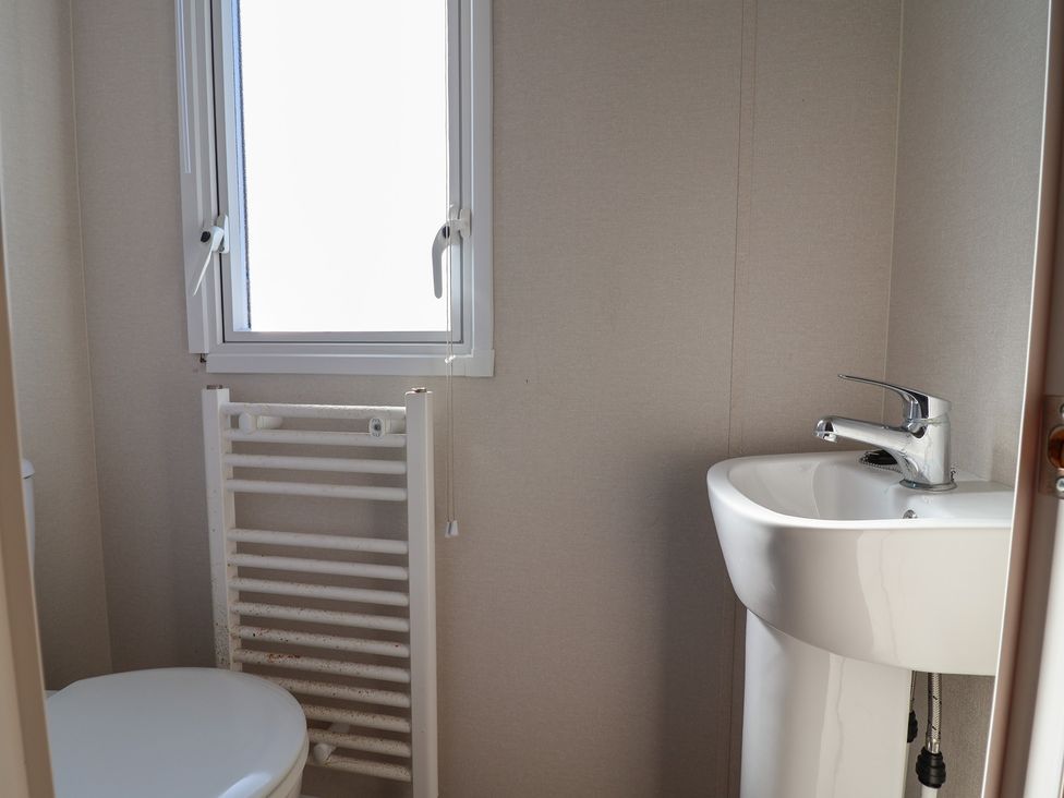 A bathroom with a toilet and sink at Golden Sands Kinmel Bay - 20528 Rhyl