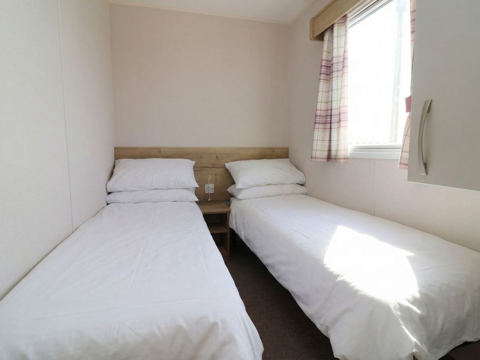 A bedroom with two beds and a window at Golden Sands Kinmel Bay - 20528 Rhyl