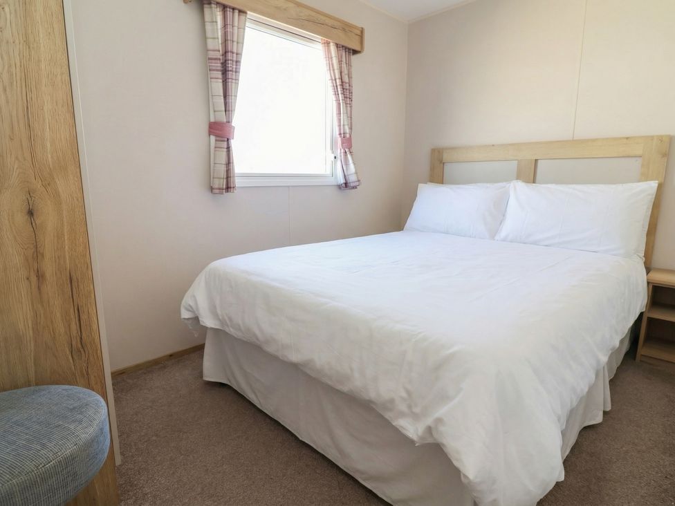 A bedroom with a bed and window at Golden Sands Kinmel Bay - 20528 Rhyl