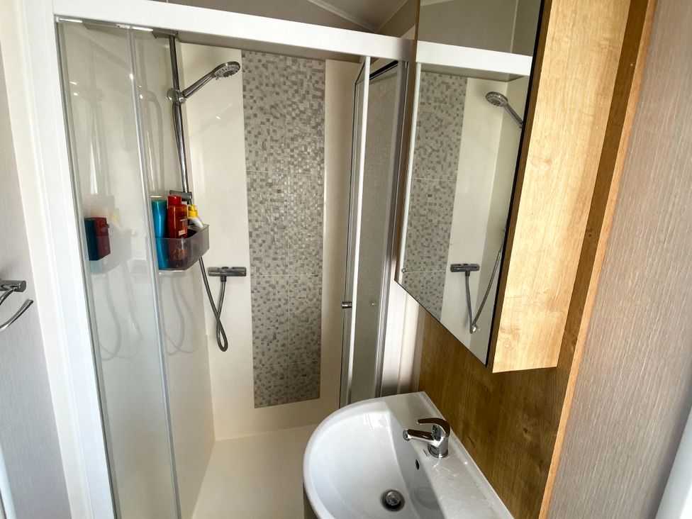 A bathroom with a shower and sink at Thornwick Bay Holiday Village - Holiday Accommodation 20633 Flamborough