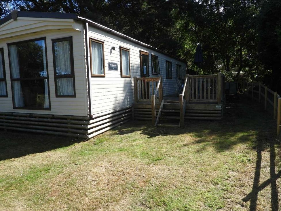 a holiday accommodation with steps leading to a deck at Kelling Heath Holiday Park - Holiday Accommodation 20665 Weybourne