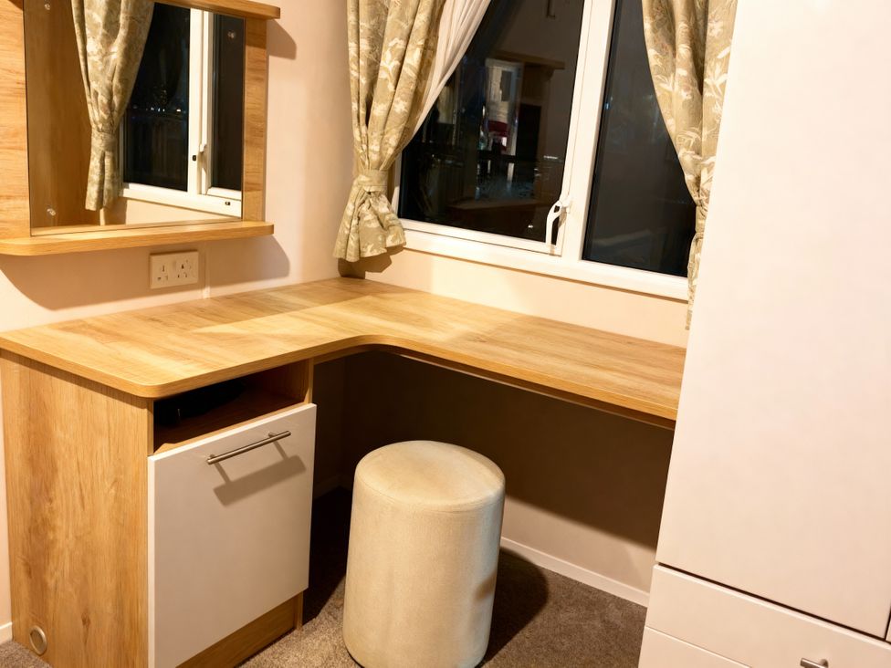 A study area with a desk and chair at Lyons Robin Hood - Holiday Accommodation 20871 in Rhyl