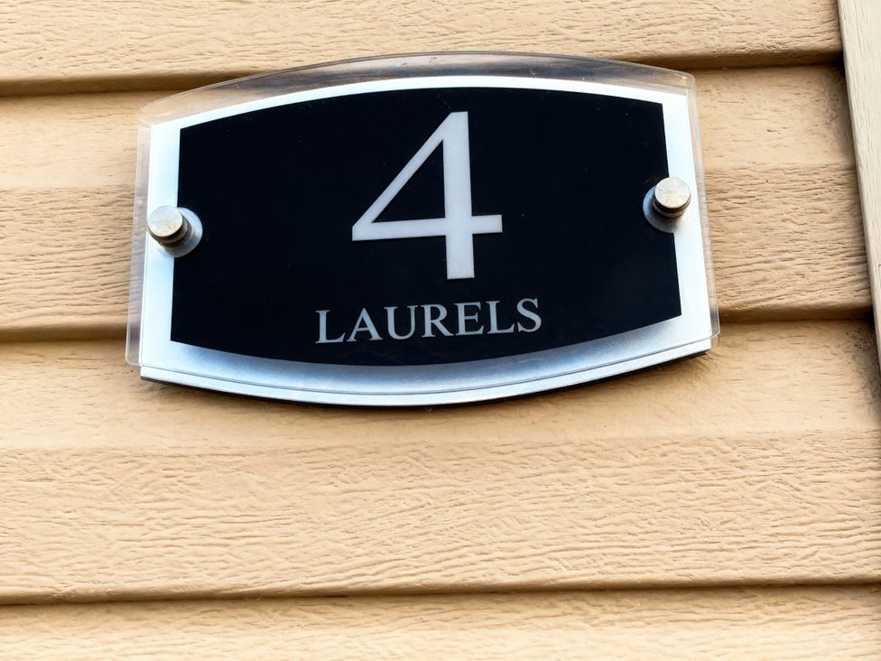 A number 4 nameplate mounted on a wall at Lyons Robin Hood - Holiday Accommodation 20871 Rhyl