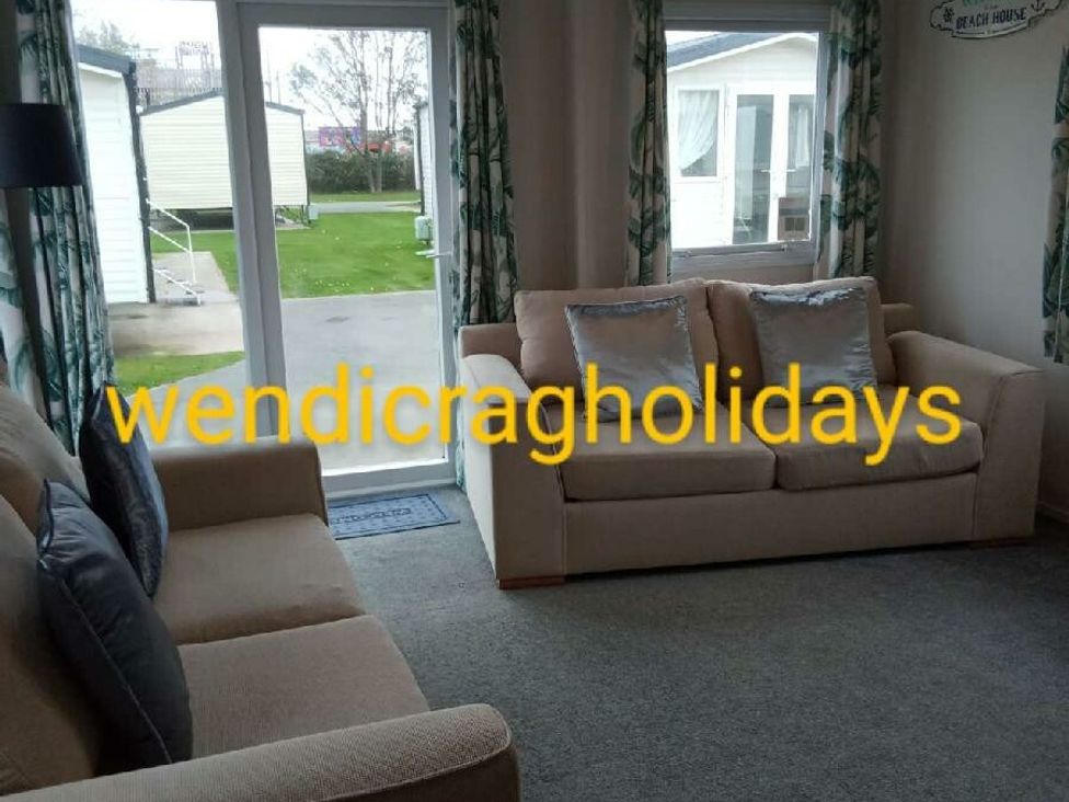 a living room with two sofas and a view of a patio at Ty Mawr Holiday Park - Holiday Accommodation 20936 Towyn