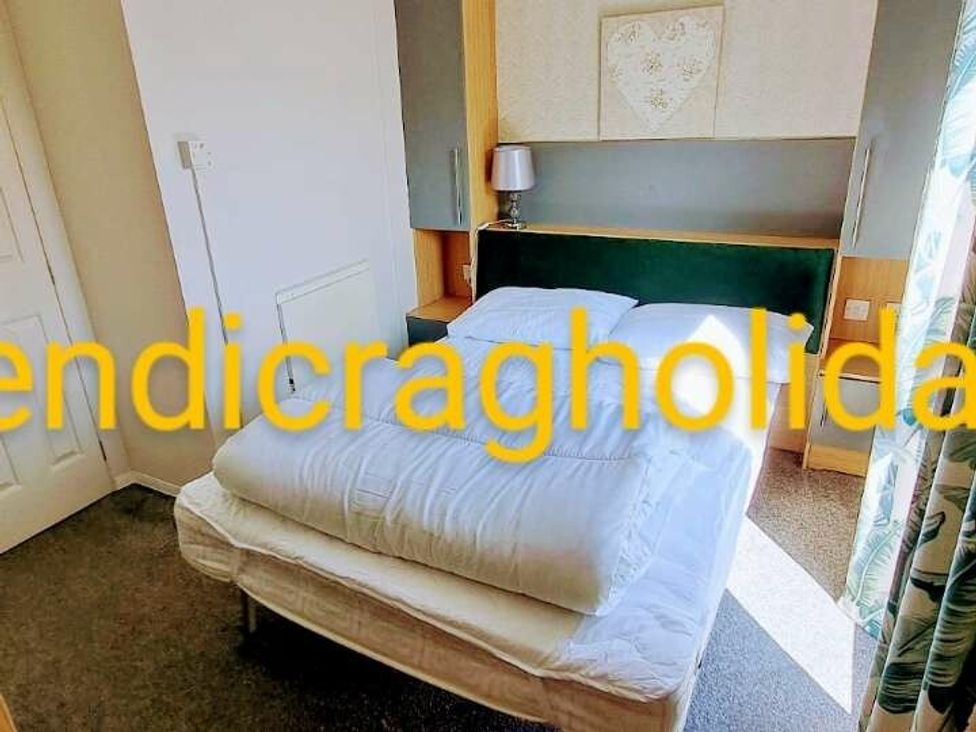 a bedroom with a bed and decorative wall art at Ty Mawr Holiday Park - Holiday Accommodation 20936 in Towyn