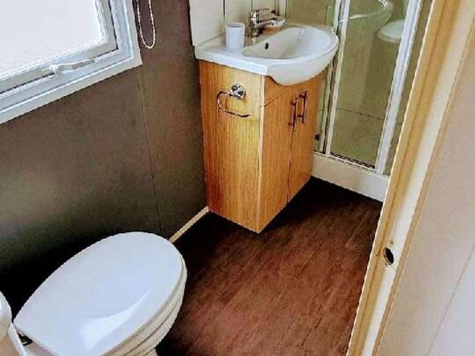 a bathroom with a sink, shower, and toilet at Ty Mawr Holiday Park - Holiday Accommodation 20936 in Towyn