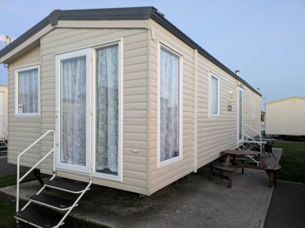 a static caravan with steps leading up to the entrance at Ty Mawr Holiday Park - Holiday Accommodation 20936 in Towyn