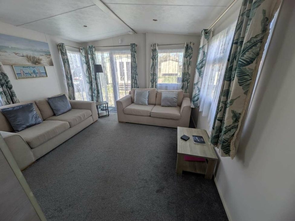 a living room with two sofas and a coffee table at Ty Mawr Holiday Park - Holiday Accommodation 20936 in Towyn