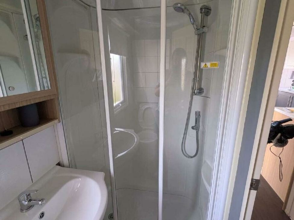 a bathroom featuring a shower, sink, and toilet at Ty Mawr Holiday Park - Holiday Accommodation 20936 in Towyn