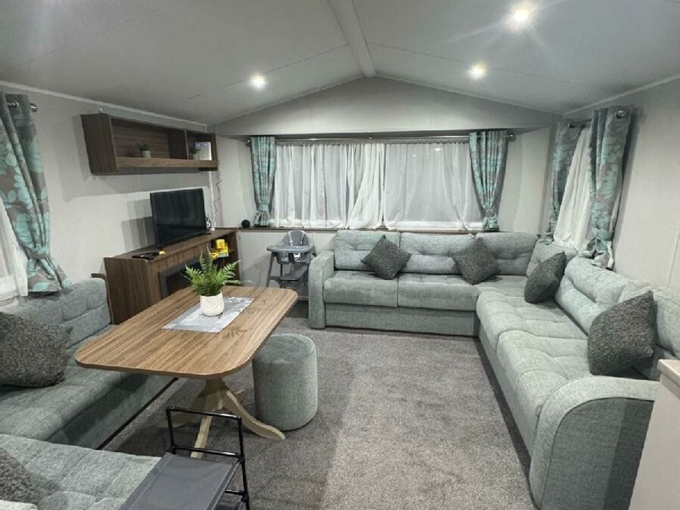 a living room with a sofa set, coffee table, and television at Butlins Skegness - Holiday Accommodation 21028 in Skegness