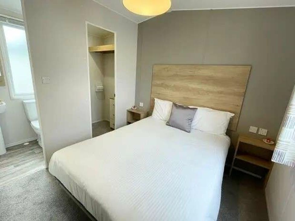 a bedroom with a double bed and en-suite bathroom at Trevella Park - Holiday Accommodation 21105 in Crantock