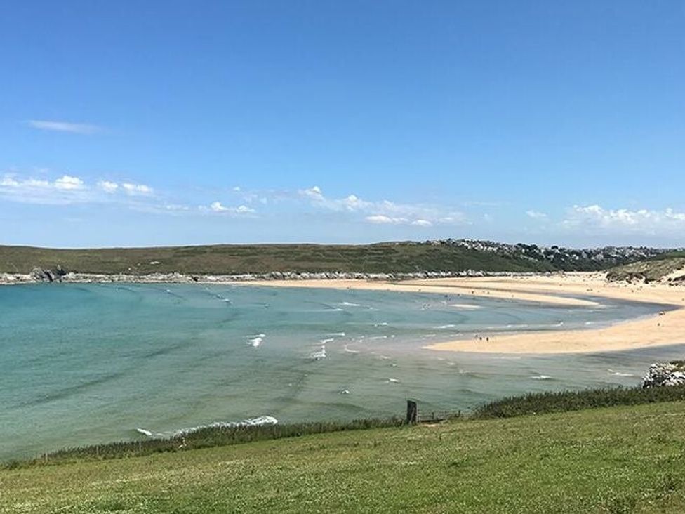 a beach with sand and blue water at Trevella Park - Holiday Accommodation 21105, Crantock