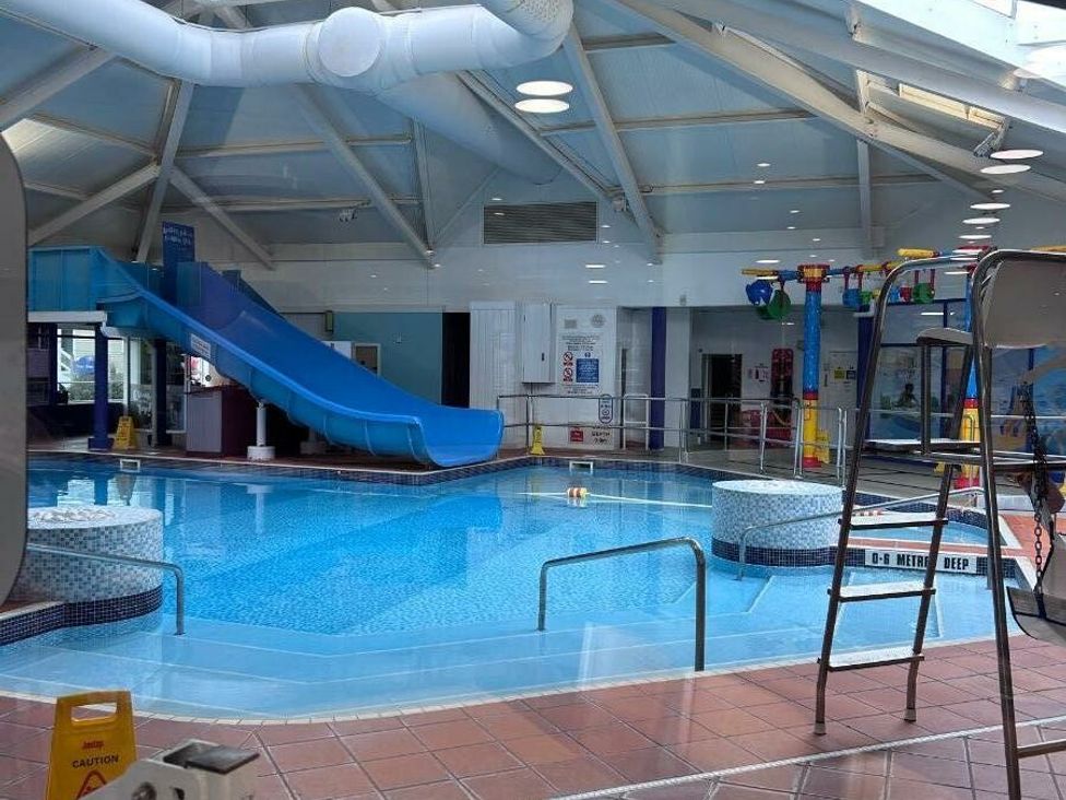 an indoor swimming pool with a blue slide and hot tubs at Cala Gran Holiday Park - Holiday Accommodation 21106, Fleetwood